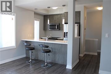 Hannon townhouse for rent - A modern kitchen with a bar stool in front of it.