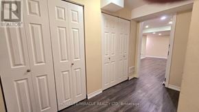 Brampton (Northwest Brampton) apartment for rent - A hallway with white doors and a sign that says "REALTOR".