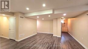 Brampton (Northwest Brampton) apartment for rent - A spacious room with wood flooring and white walls.