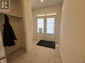 Kawartha Lakes (Lindsay) multi-family for rent - A hallway with a coat hanging on the railing.