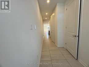 Kawartha Lakes (Lindsay) multi-family for rent - A hallway with white walls and tiled flooring.