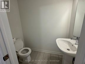 Kawartha Lakes (Lindsay) multi-family for rent - A white toilet and sink in a small bathroom.