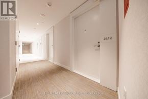 Toronto (Kensington-Chinatown) condo for rent - A hallway with a door numbered 2612 and a brokerage sign.