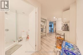 Toronto (Kensington-Chinatown) condo for rent - A bathroom with a glass shower door and a toilet.