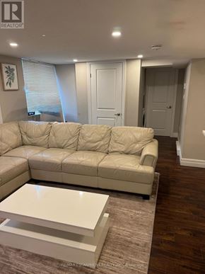 Kitchener apartment for rent - A living room with a white sofa and a coffee table.