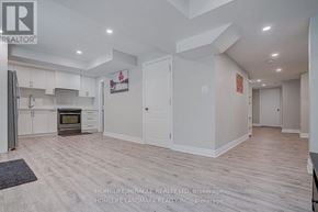 Ajax (Northeast Ajax) apartment for rent - A spacious kitchen with white cabinets and a wooden floor.