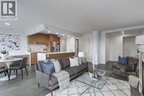 Vancouver apartment for rent - A modern living room with a grey sofa and a glass coffee table.