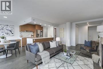Vancouver apartment for rent - A modern living room with a grey sofa and a glass coffee table.