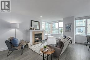 Vancouver apartment for rent - A modern living room with a fireplace and a grey couch.