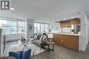 Vancouver apartment for rent - A modern living room with a grey sofa and a glass coffee table.