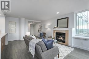 Vancouver apartment for rent - A living room with a grey couch and a fireplace.