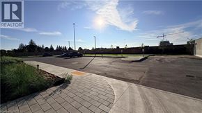 Kitchener condo for rent - A sunny day at a parking lot with a clear blue sky.