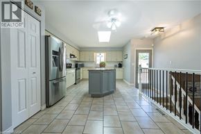 London apartment for rent - A kitchen with tile flooring and stainless steel appliances.