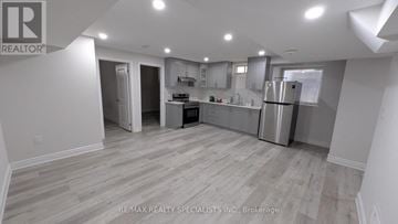 Brampton (Bram West) apartment for rent - A kitchen with a refrigerator, cabinets, and a countertop.