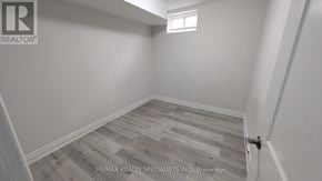 Brampton (Bram West) apartment for rent - A room with wooden flooring and a window.