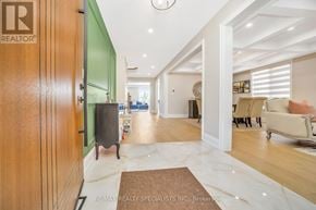Brampton (Bram East) apartment for rent - A living room with a brown rug and a green accent wall.