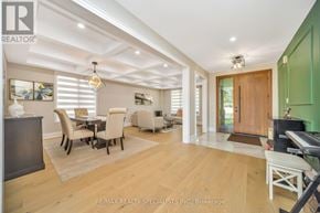 Brampton (Bram East) apartment for rent - A well-lit, spacious living room with a dining area and a piano.