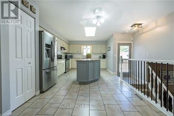 London North (North C) apartment for rent - A kitchen with white cabinets and a tile floor.