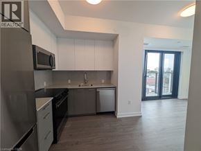 Kitchener condo for rent - A kitchen with a refrigerator, dishwasher, and oven.