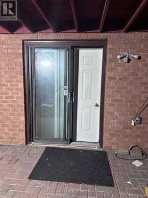 Pickering (Highbush) apartment for rent - A door with a glass panel is closed and there is a doormat in front of it.