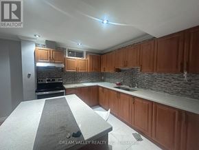 Pickering (Highbush) apartment for rent - A kitchen with wooden cabinets and a granite countertop.