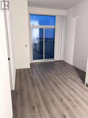 Vaughan (Vaughan Corporate Centre) condo for rent - A room with a view of the city through a window.