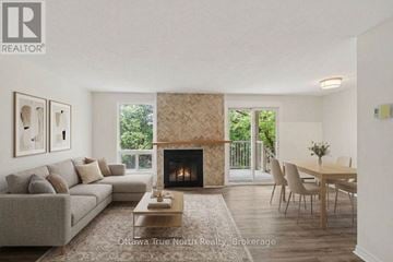 Ottawa townhouse for rent - A living room with a fireplace and a dining table.