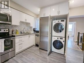 Toronto (Dovercourt-Wallace Emerson-Junction) apartment for rent - A modern kitchen with a washer and dryer built into the cabinetry.