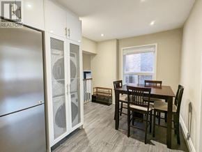 Toronto (Dovercourt-Wallace Emerson-Junction) apartment for rent - A kitchen with a refrigerator, table and chairs.