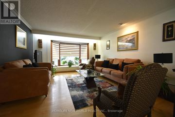 Toronto (Highland Creek) apartment for rent - A living room with a brown couch and a glass coffee table.
