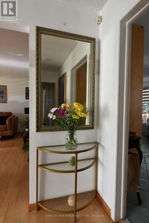 Toronto (Highland Creek) apartment for rent - A vase of flowers sits on a gold shelf in a hallway.