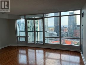 Toronto (Waterfront Communities) condo for rent - A room with a large window overlooking a cityscape.
