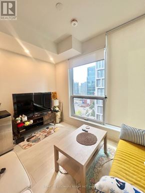 Toronto (Waterfront Communities) condo for rent - A living room with a fireplace and a couch.
