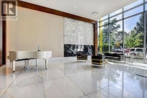 Burnaby apartment for rent - A white piano is in a room with a marble wall and floor.