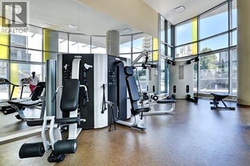Burnaby apartment for rent - A gym with a variety of equipment including a treadmill, weights, and a bench press.