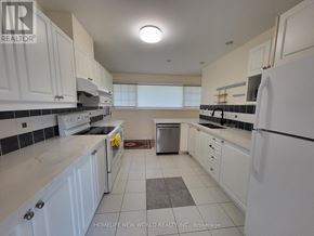 Markham (Bullock) apartment for rent - A kitchen with white cabinets and appliances.