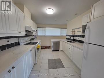Markham (Bullock) apartment for rent - A kitchen with white cabinets and appliances.