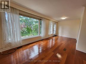 Markham (Bullock) apartment for rent - A room with wooden floors and a large window with curtains.