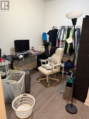 Toronto (Parkwoods-Donalda) condo for rent - A room with a desk, chair, and clothes hanging on a rack.