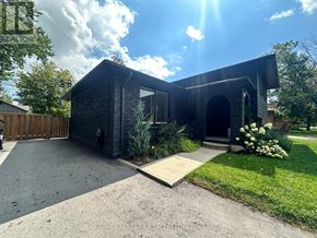 Welland (N. Welland) apartment for rent - A modern house with a black exterior and a stone pathway leading to the entrance.