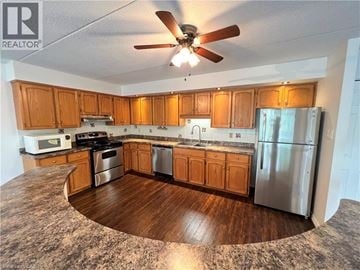 Waterloo condo for rent - A kitchen with wooden cabinets and a stainless steel refrigerator.