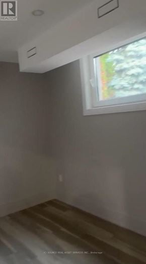 Vaughan (Kleinburg) apartment for rent - A room with a window and a wooden floor.