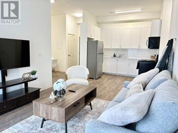 Belleville (Belleville Ward) multi-family for rent - A living room with a white couch and a wooden coffee table.