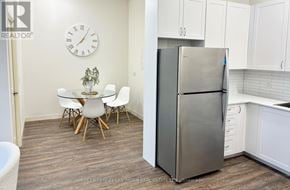 Belleville (Belleville Ward) multi-family for rent - A kitchen with a refrigerator, table and chairs.