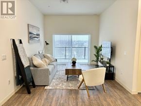 Belleville (Belleville Ward) multi-family for rent - A living room with a grey couch, a coffee table, and a painting on the wall.