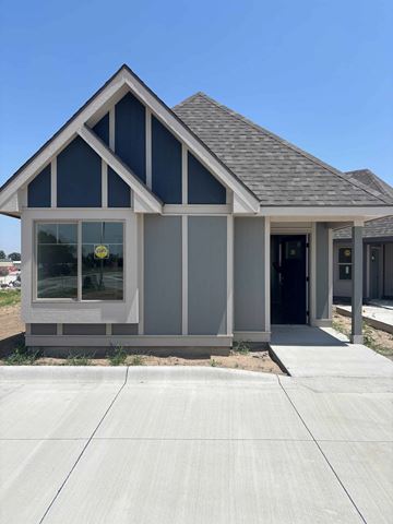 Dodge City apartment for rent - A modern house with a grey and white exterior and a black door.