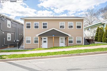 Dartmouth apartment for rent - A two-story house with a beige exterior and a white door.