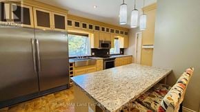 Saugeen Shores apartment for rent - A kitchen with a granite countertop and a refrigerator.