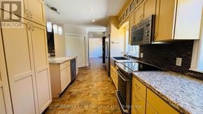 Saugeen Shores apartment for rent - A kitchen with a refrigerator, microwave, and oven.