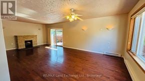 Saugeen Shores apartment for rent - A room with a fireplace and a ceiling fan.